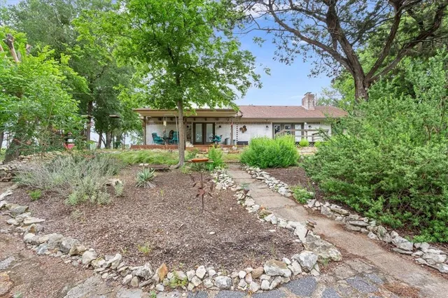a front view of a house with a garden