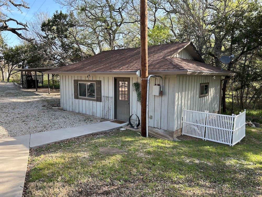 649 Wedgewood Drive China Spring, TX 76633 - Photo 38 of 39 View of front of property featuring board and batten siding, a front lawn, and roof with shingles