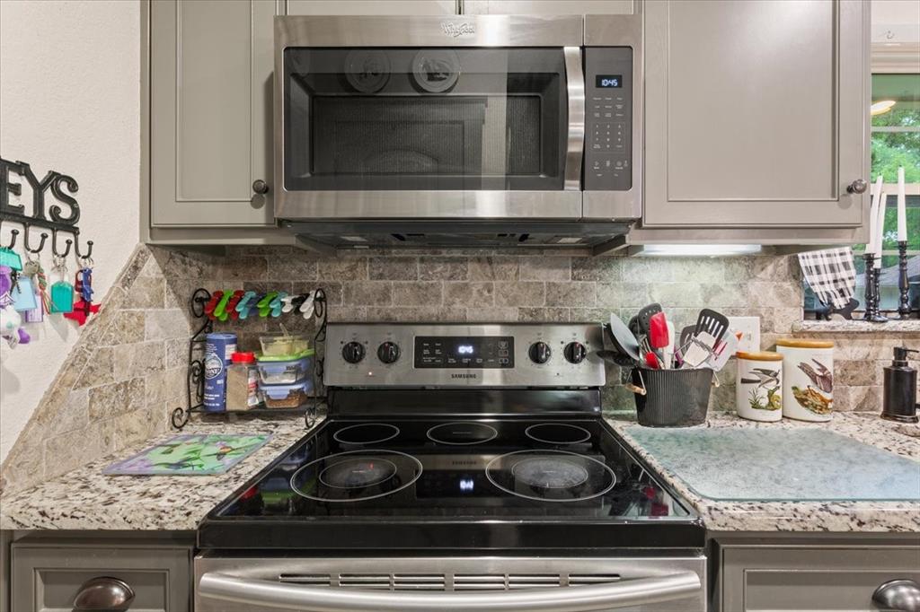 649 Wedgewood Drive China Spring, TX 76633 - Photo 10 of 39 Kitchen featuring stainless steel appliances, gray cabinetry, and decorative backsplash