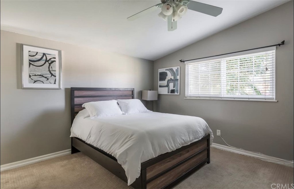 2378 Cornell Drive Costa Mesa, CA 92626 - Photo 17 of 40 a bedroom with a bed and a chandelier