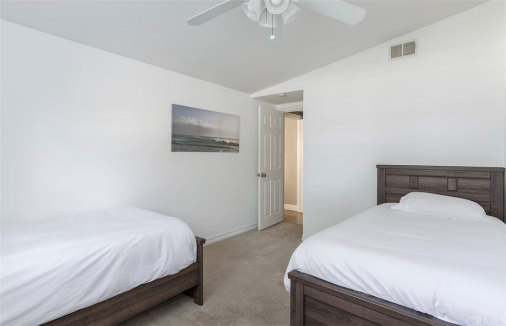 2378 Cornell Drive Costa Mesa, CA 92626 - Photo 18 of 40 a bedroom with a bed and a chandelier