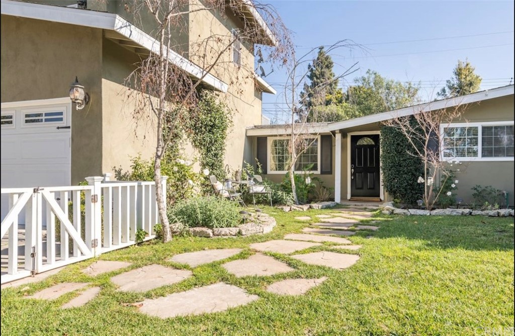2378 Cornell Drive Costa Mesa, CA 92626 - Photo 3 of 40 a view of a house with a small yard and flower plants