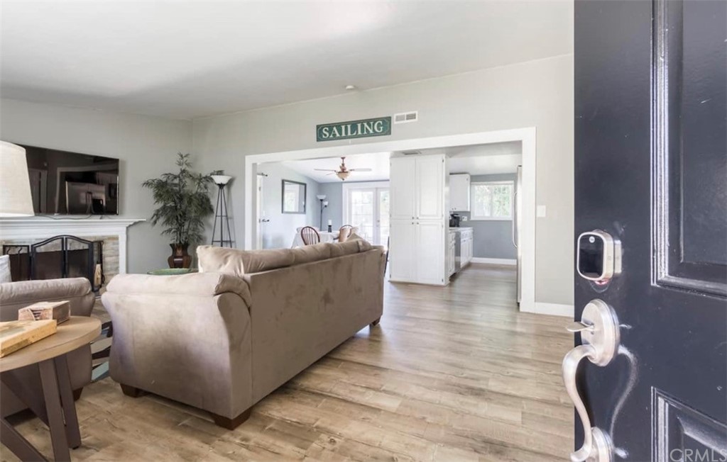 2378 Cornell Drive Costa Mesa, CA 92626 - Photo 5 of 40 a living room with furniture a fireplace and a flat screen tv