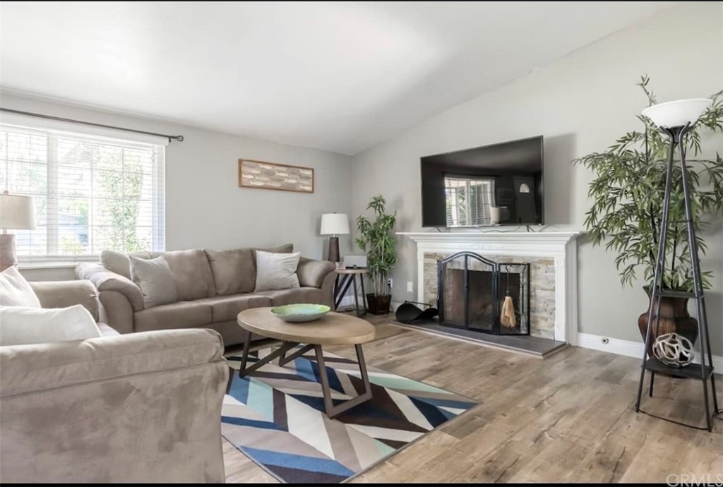 2378 Cornell Drive Costa Mesa, CA 92626 - Photo 6 of 40 a living room with furniture a fireplace and a flat screen tv