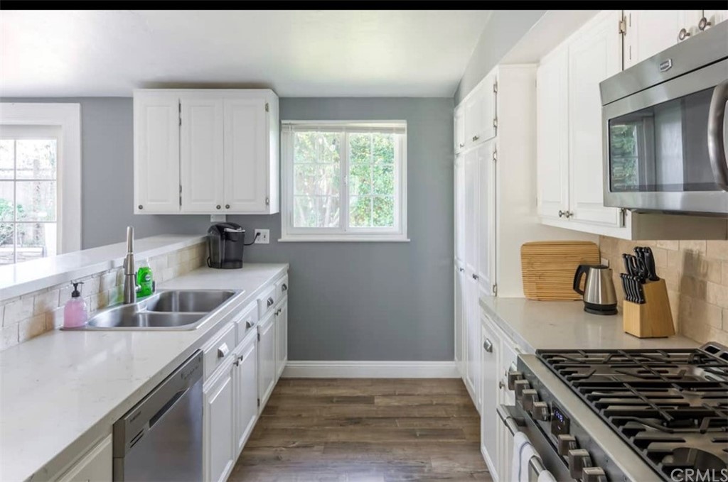 2378 Cornell Drive Costa Mesa, CA 92626 - Photo 8 of 40 a kitchen with granite countertop a sink stove and cabinets