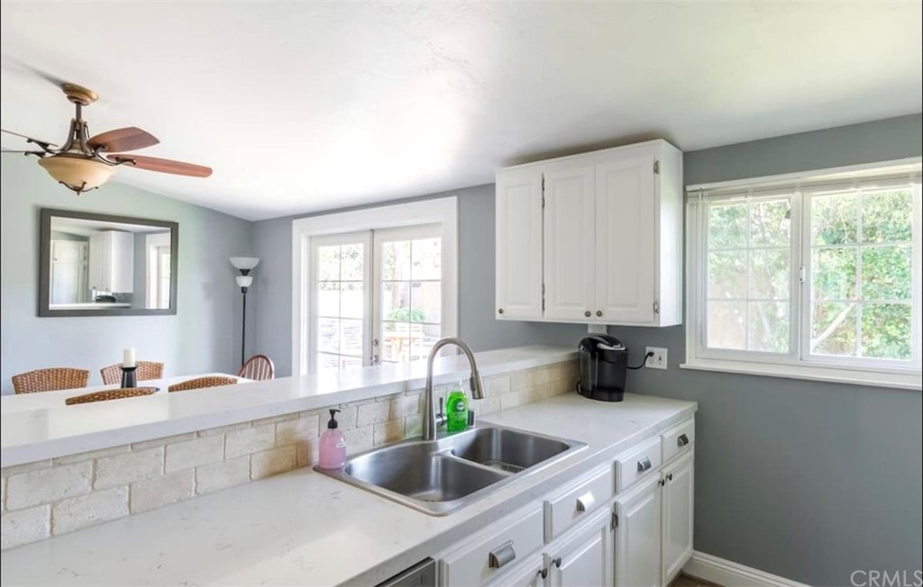 2378 Cornell Drive Costa Mesa, CA 92626 - Photo 10 of 40 a kitchen with stainless steel appliances a sink a counter and a window