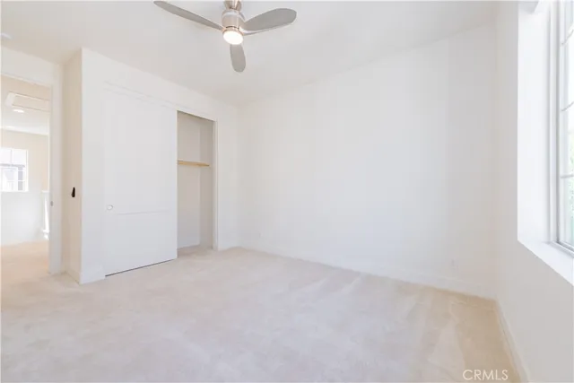 a bedroom with a bed and a potted plant