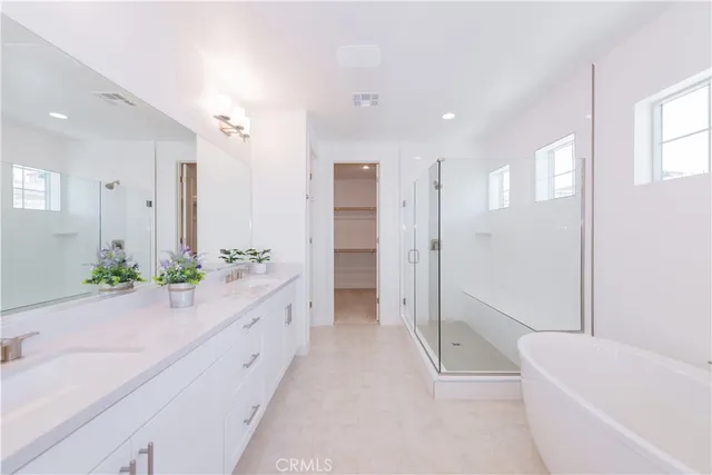a spacious bathroom with a double vanity sink mirror and
