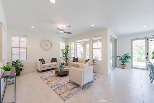a living room with furniture and a potted plant