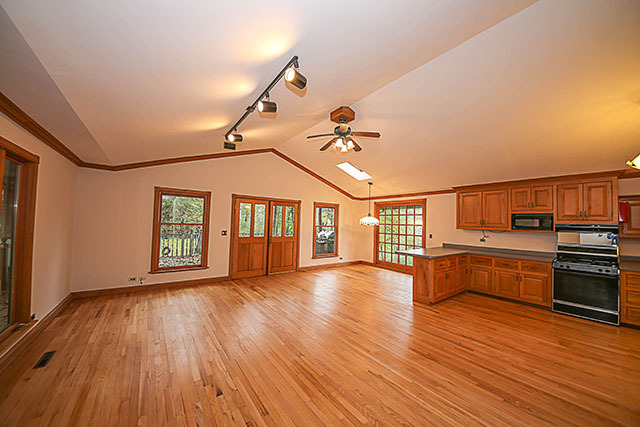 S436 Winfield Road Winfield, IL 60190 - Photo 12 of 23 a view of an empty room with wooden floor kitchen view and a window