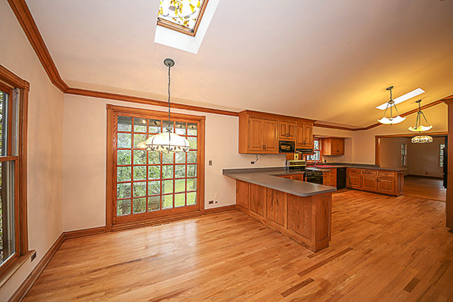 S436 Winfield Road Winfield, IL 60190 - Photo 14 of 23 a kitchen with stainless steel appliances granite countertop a sink cabinets and wooden floor