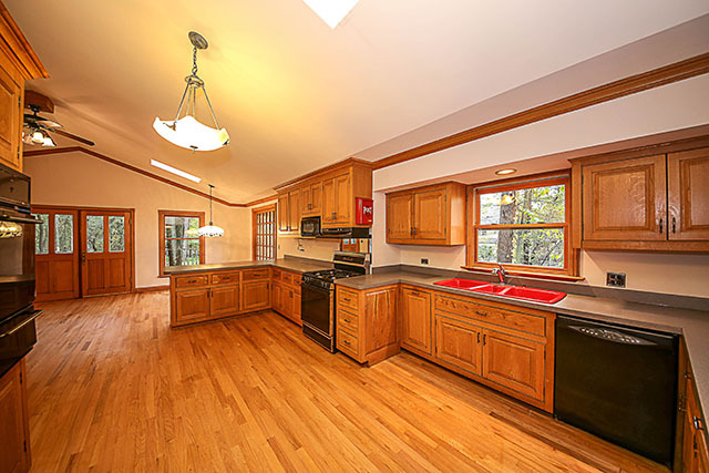 S436 Winfield Road Winfield, IL 60190 - Photo 9 of 23 a kitchen with stainless steel appliances granite countertop a sink cabinets and wooden floor