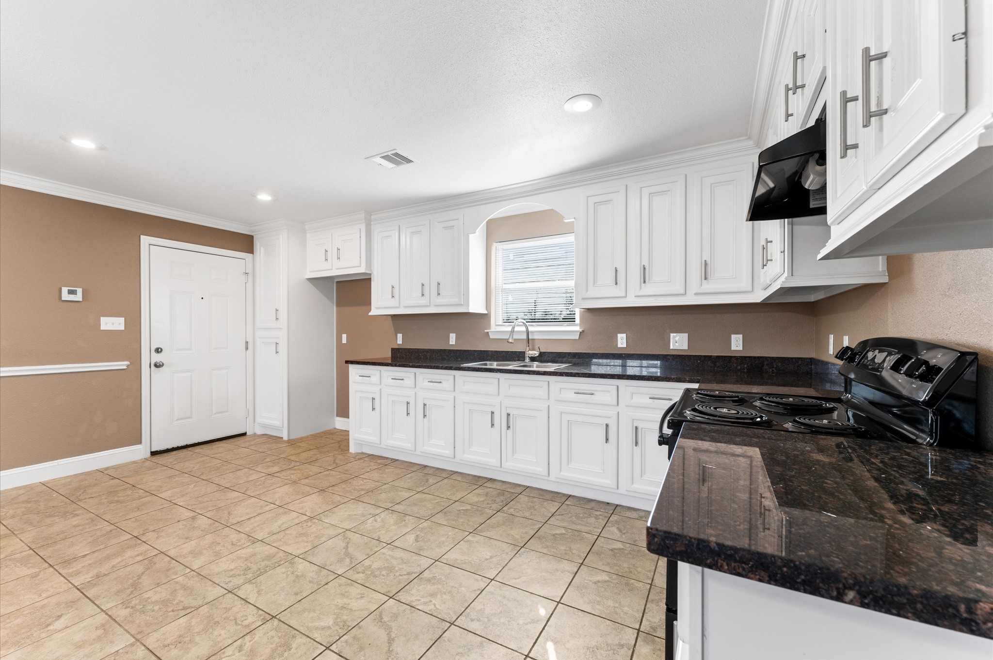 8221 Brockton Street Houston, TX 77017 - Photo 11 of 32 a kitchen with granite countertop a stove sink and cabinets
