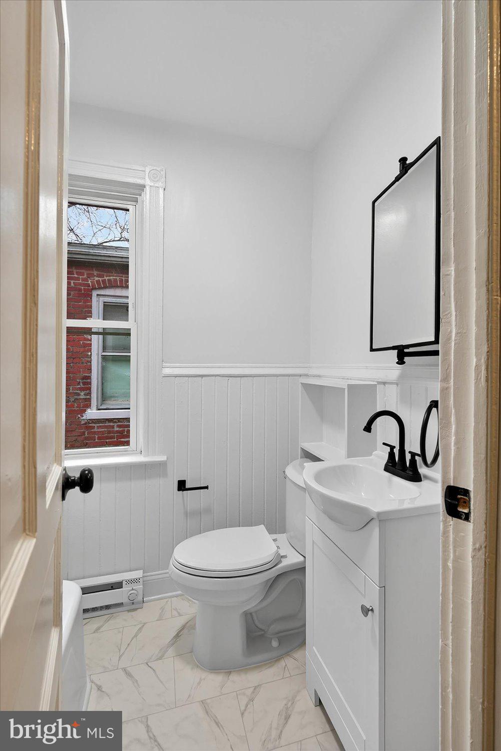 718 High Street Lancaster, PA 17603 - Photo 11 of 33 a bathroom with a toilet a sink and mirror