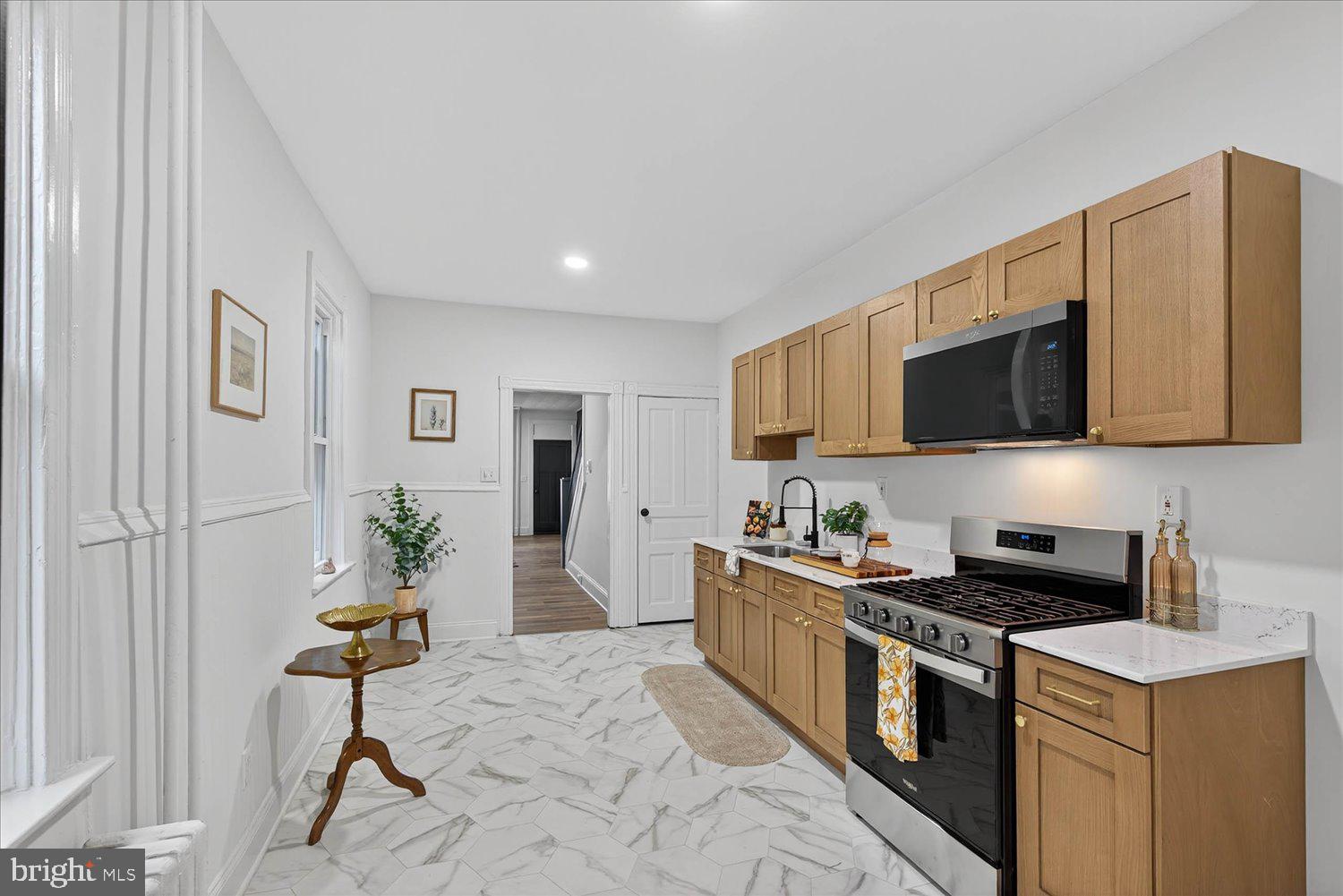 718 High Street Lancaster, PA 17603 - Photo 7 of 33 a kitchen with stainless steel appliances kitchen island granite countertop a stove a sink and a microwave