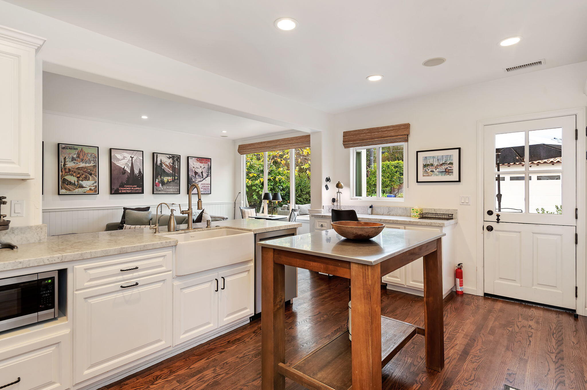 3020 Puesta Del Sol Santa Barbara, CA 93105 - Photo 10 of 33 a kitchen with stainless steel appliances kitchen island granite countertop wooden floors and white cabinets