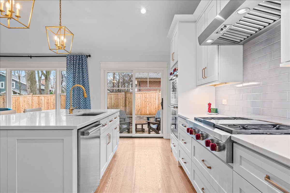 140 West Old Elm Road Lake Forest, IL 60045 - Photo 14 of 38 a kitchen with stainless steel appliances granite countertop a stove and a wooden cabinets
