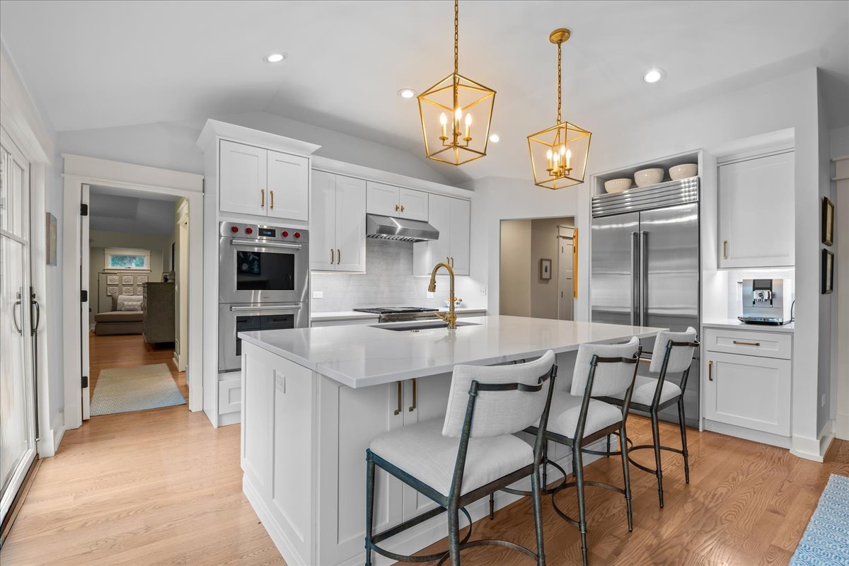 140 West Old Elm Road Lake Forest, IL 60045 - Photo 15 of 38 a kitchen with stainless steel appliances kitchen island granite countertop a table chairs and a refrigerator