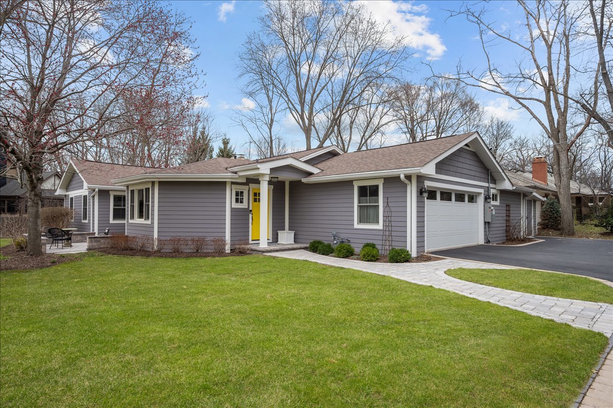 140 West Old Elm Road Lake Forest, IL 60045 - Photo 2 of 38 a front view of a house with a garden and trees