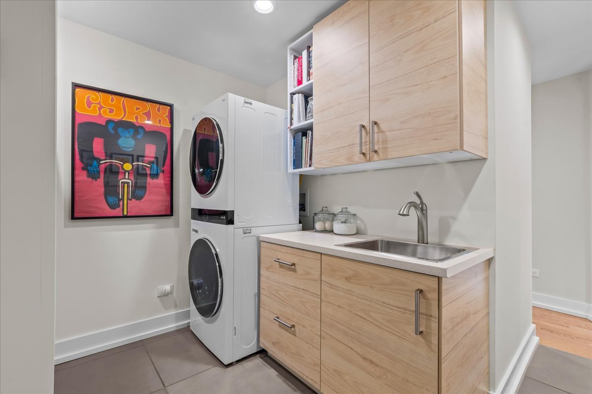 140 West Old Elm Road Lake Forest, IL 60045 - Photo 21 of 38 a utility room with cabinets dryer and washer