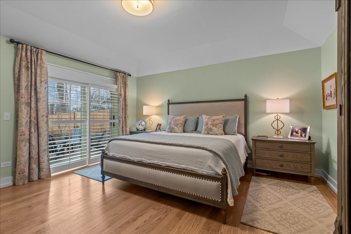 140 West Old Elm Road Lake Forest, IL 60045 - Photo 24 of 38 a spacious bedroom with a bed and wooden floor