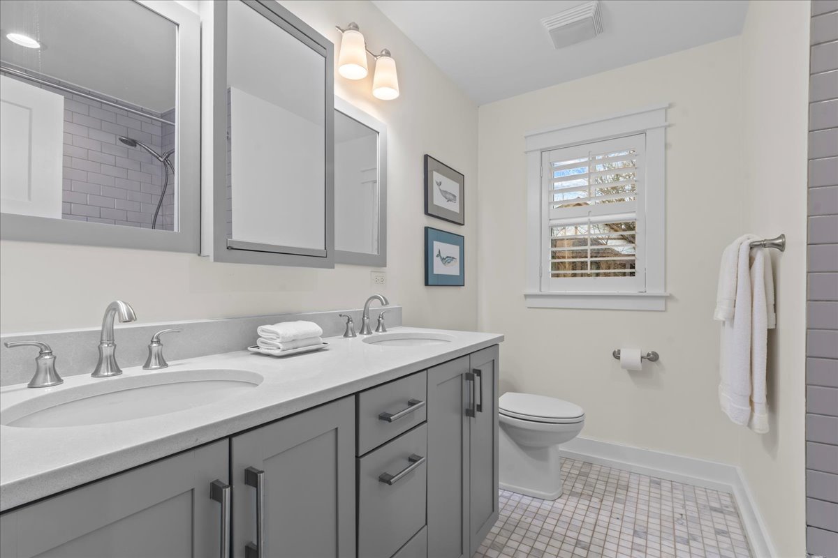 140 West Old Elm Road Lake Forest, IL 60045 - Photo 32 of 38 a bathroom with a granite countertop sink a toilet and a mirror