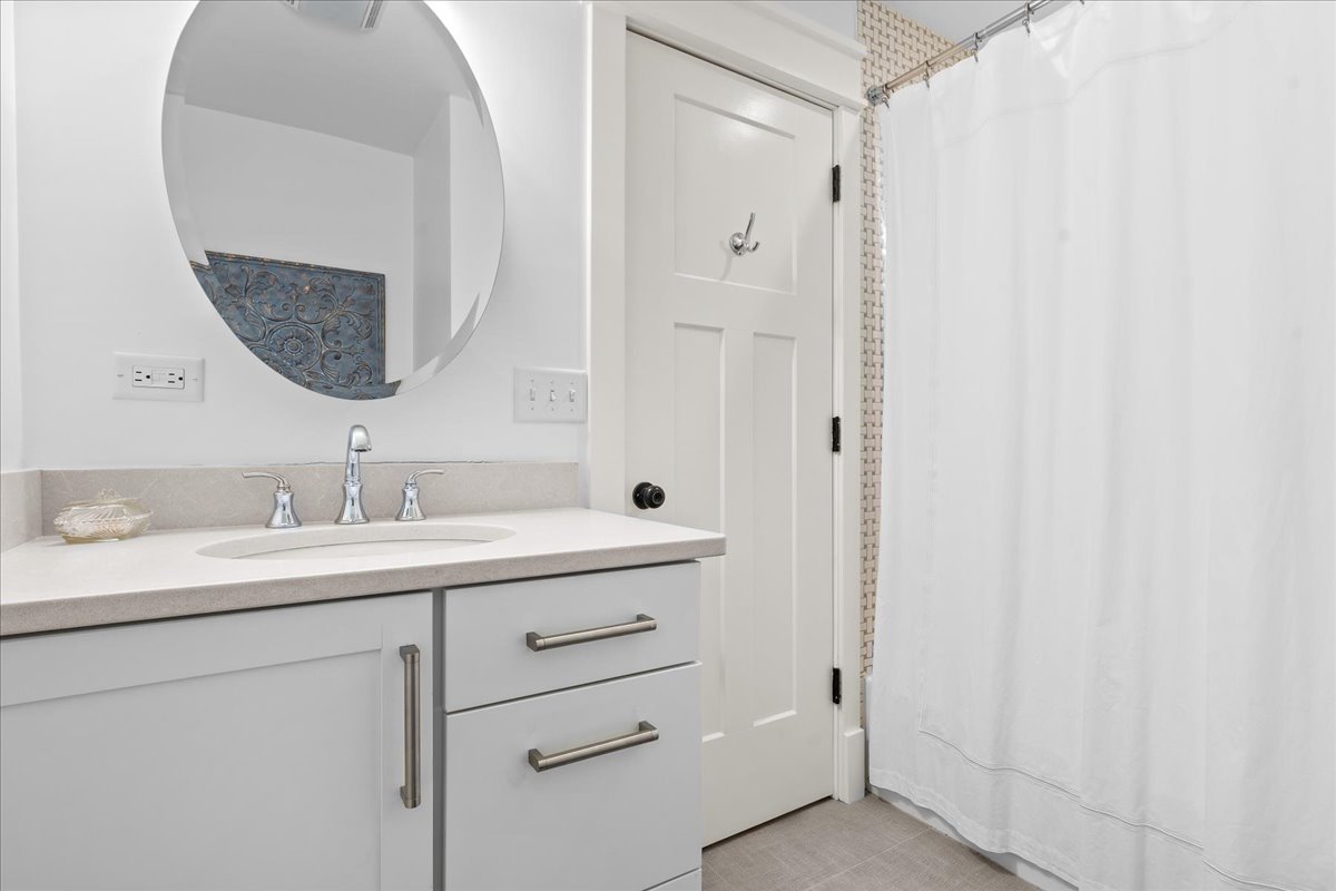 140 West Old Elm Road Lake Forest, IL 60045 - Photo 33 of 38 a bathroom with a double vanity sink and mirror