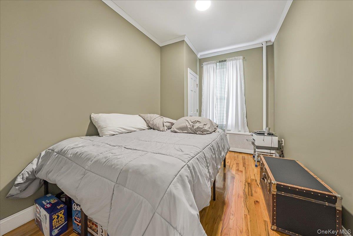 137 West 142nd Street, Unit 4A Manhattan, NY 10030 - Photo 12 of 24 Bedroom with light wood-style floors and ornamental molding