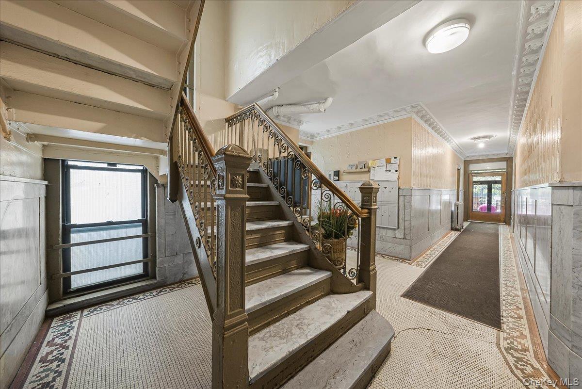 137 West 142nd Street, Unit 4A Manhattan, NY 10030 - Photo 19 of 24 Stairs featuring a wainscoted wall