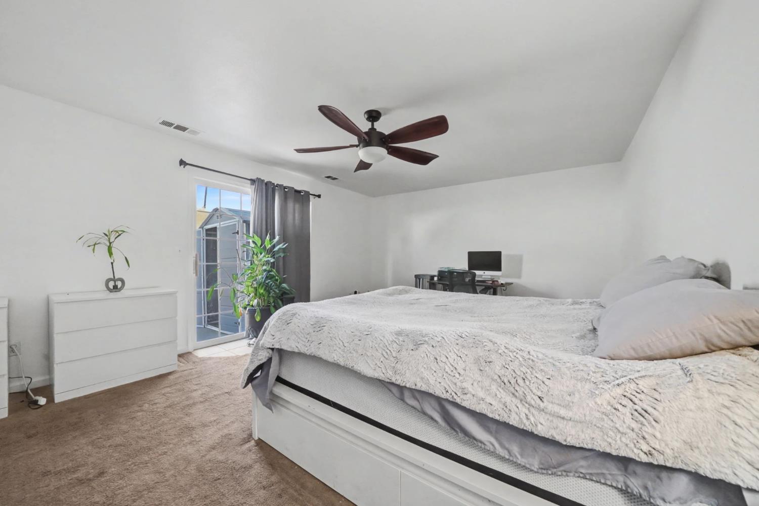 7761 Jenny Lind Road Valley Springs, CA 95252 - Photo 17 of 35 a bedroom with a bed and a large window