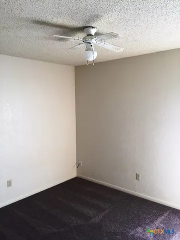 an empty room with a wooden floor and a window