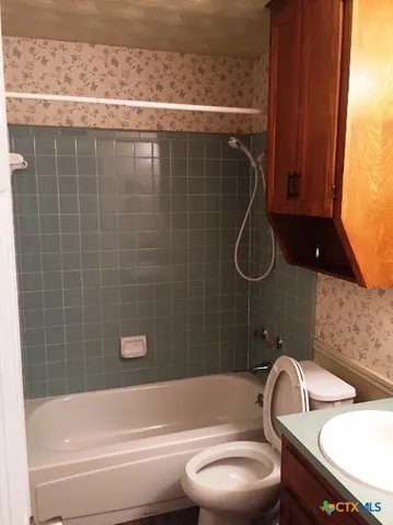 a bathroom with a sink a toilet and bathtub