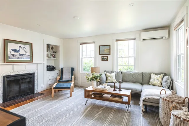 a living room with furniture a rug and a fireplace