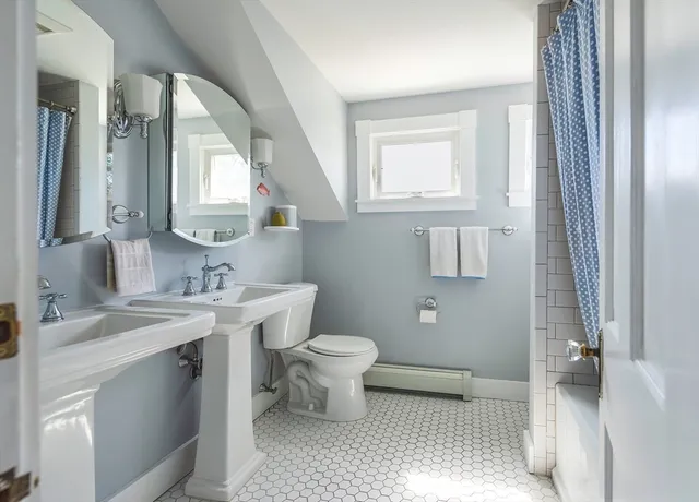 a bathroom with a toilet sink and mirror