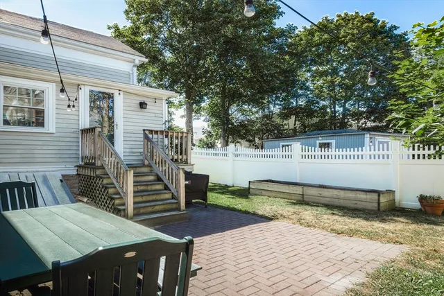 a backyard of a house with barbeque oven table and chairs