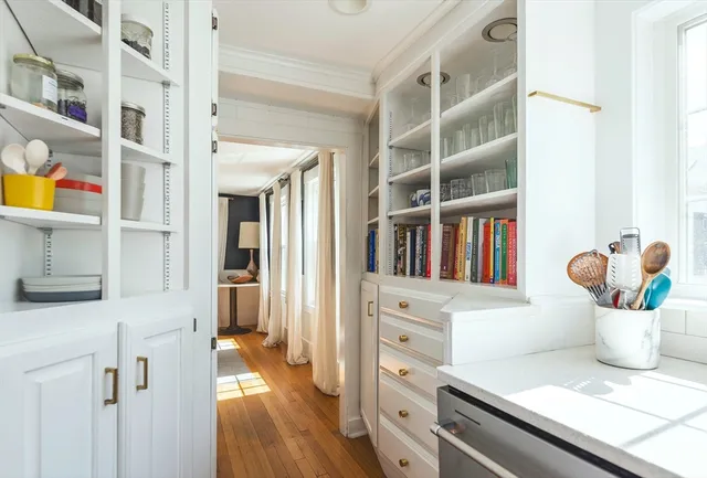 a kitchen with a stove and a wooden floor