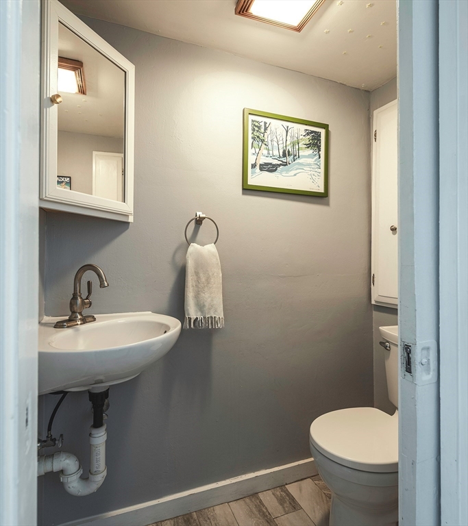 30 Paradise Road Swampscott, MA 01907 - Photo 8 of 24 a bathroom with a toilet sink and mirror