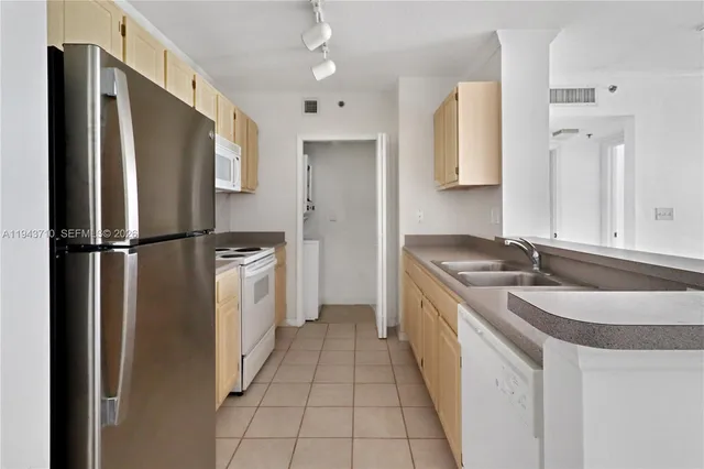 a kitchen with a sink stove and refrigerator