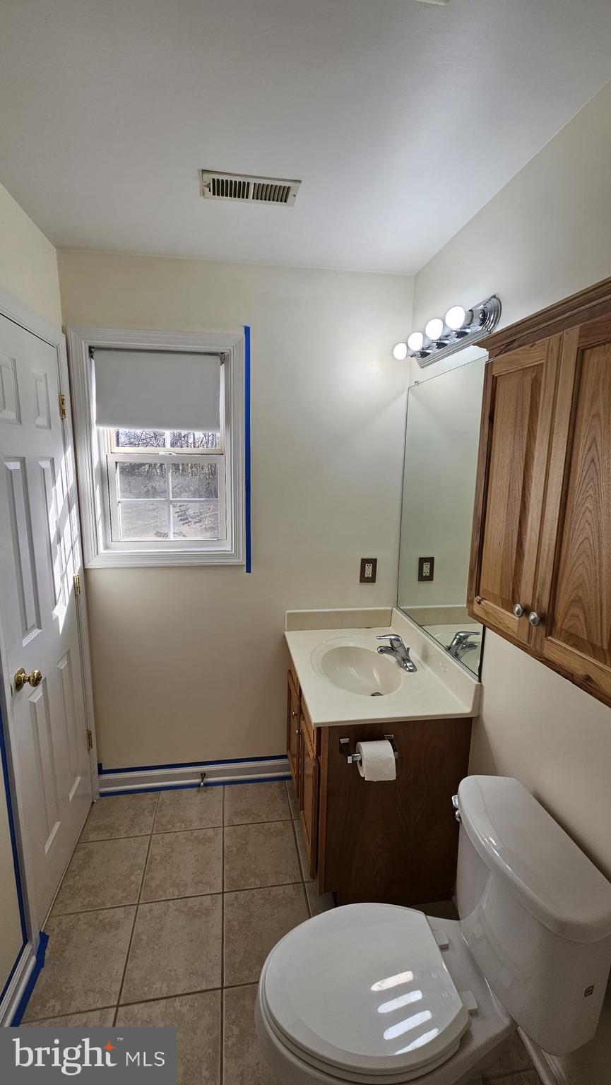 201 Eastside Lane Winchester, VA 22602 - Photo 15 of 21 a bathroom with a granite countertop toilet sink and mirror