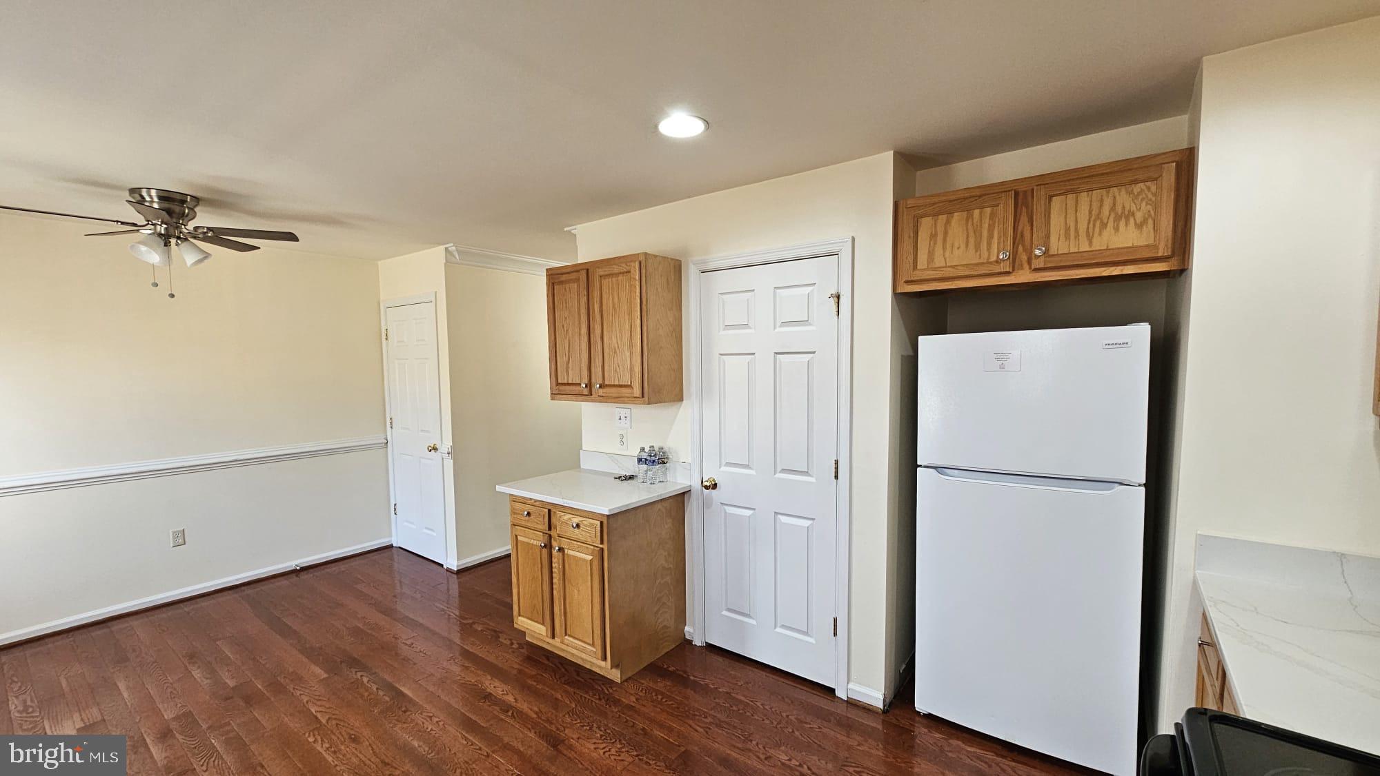 201 Eastside Lane Winchester, VA 22602 - Photo 17 of 21 a room with a refrigerator a sink and cabinets
