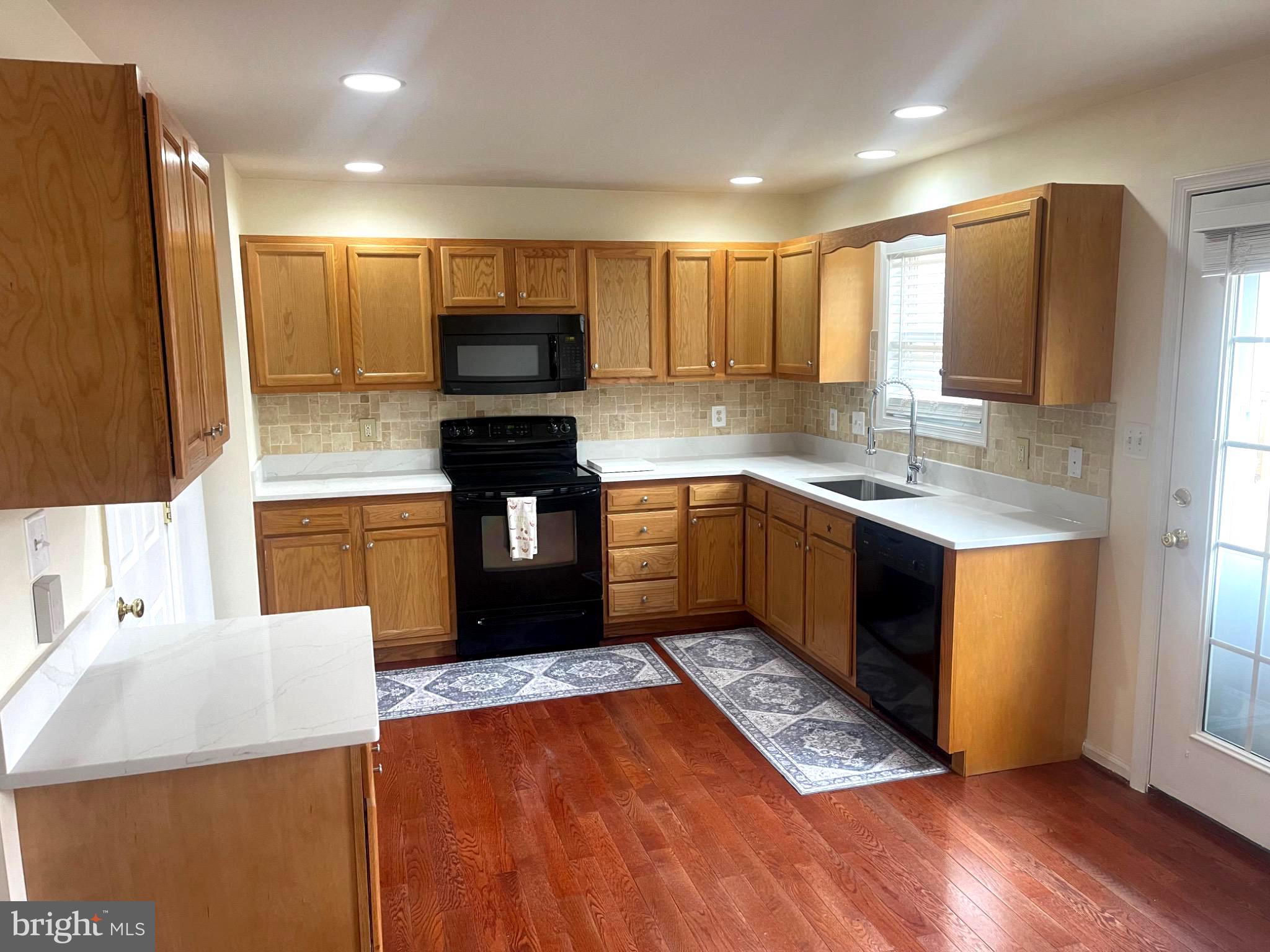 201 Eastside Lane Winchester, VA 22602 - Photo 3 of 21 a kitchen with stainless steel appliances granite countertop a sink counter space cabinets and a large window
