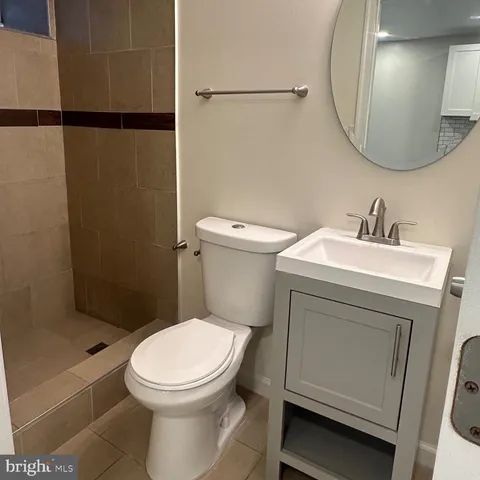 a white toilet sitting next to a bathroom sink