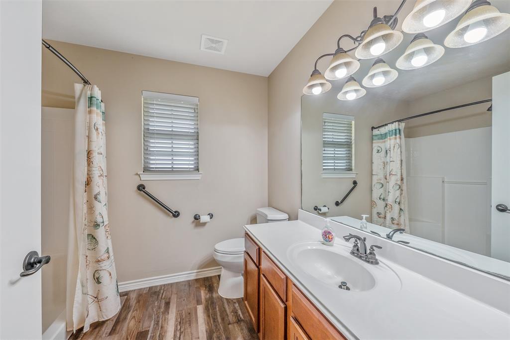 421 West Cumberland Road, Unit 205 Tyler, TX 75703 - Photo 16 of 24 a bathroom with a sink a toilet and a mirror