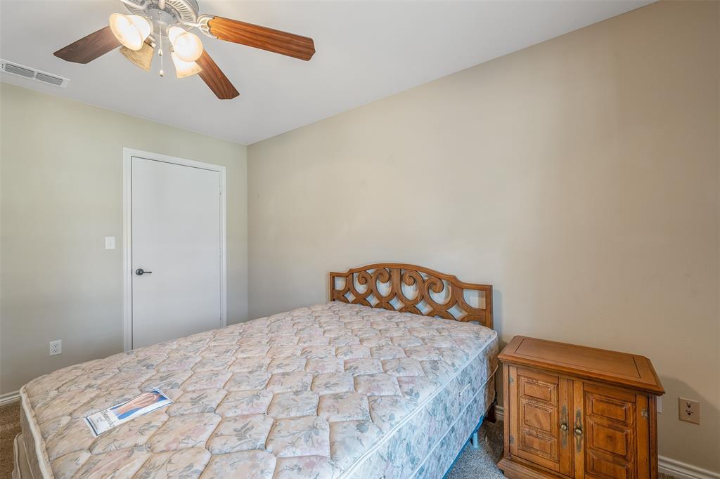 421 West Cumberland Road, Unit 205 Tyler, TX 75703 - Photo 18 of 24 a bedroom with a bed and a chandelier