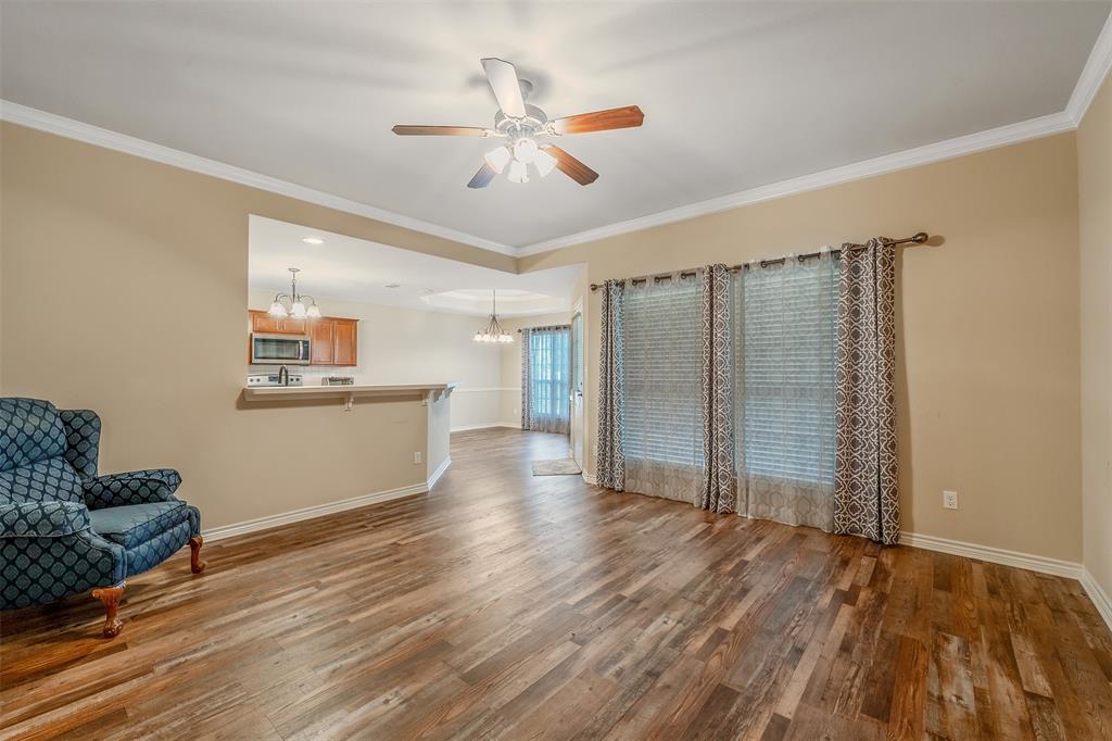 421 West Cumberland Road, Unit 205 Tyler, TX 75703 - Photo 7 of 24 a view of an empty room with wooden floor and a ceiling fan