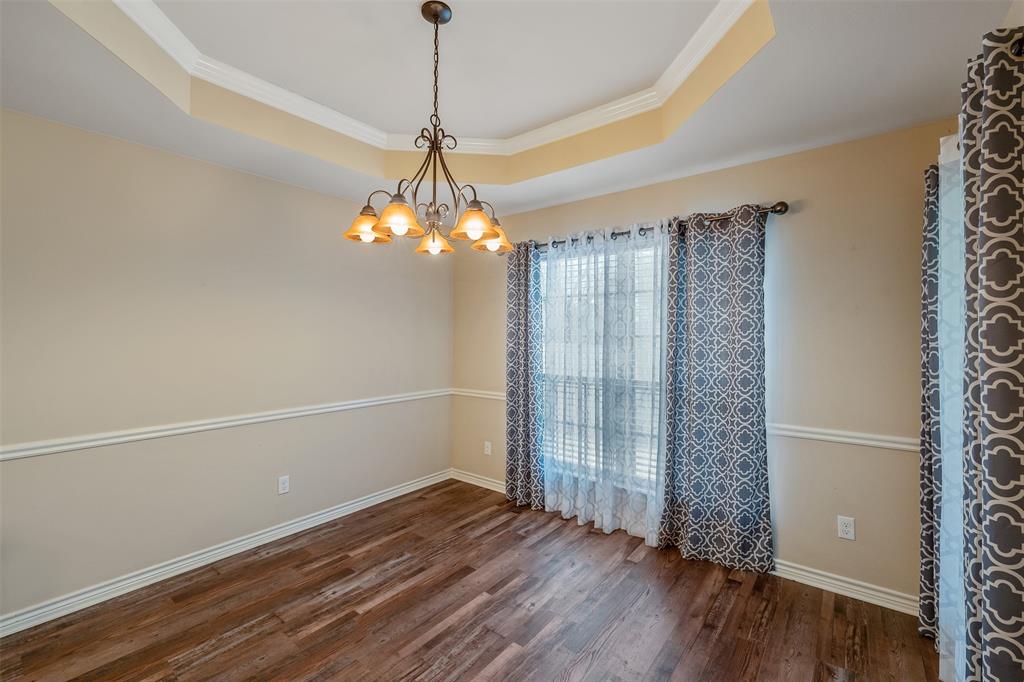421 West Cumberland Road, Unit 205 Tyler, TX 75703 - Photo 10 of 24 a view of a room with wooden floor chandelier and closet