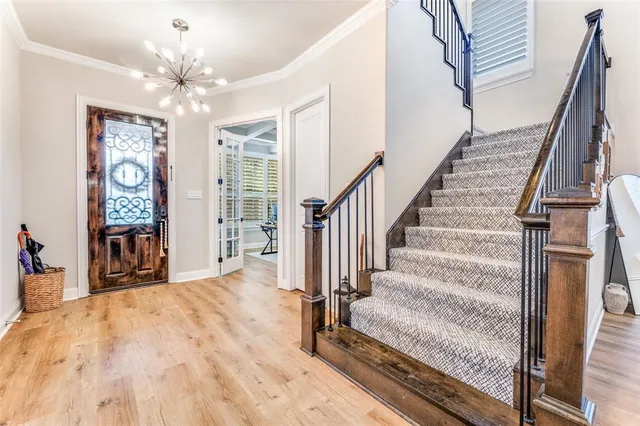 a view of a livingroom with wooden floor and stairs