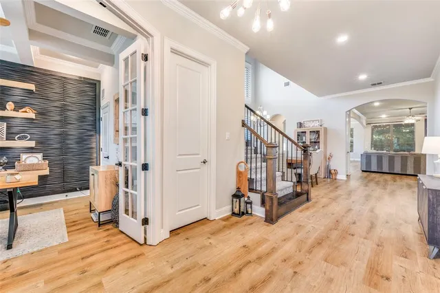a view of an entryway with wooden floor and livingroom