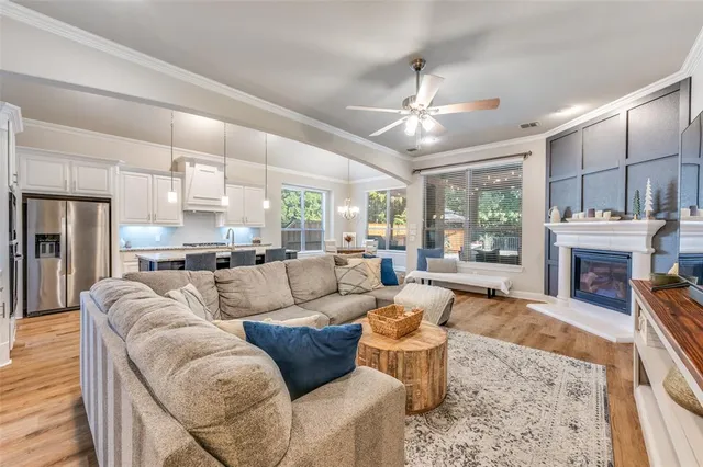 a living room with furniture fireplace and a chandelier