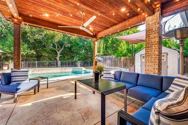 a view of a patio with couches and pool